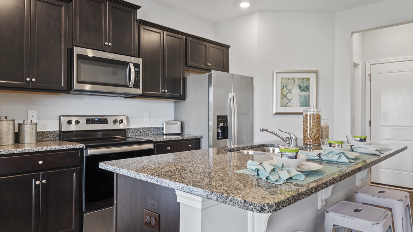 Modern Hubbard kitchen with stainless steel appliances, granite countertops, and a spacious island